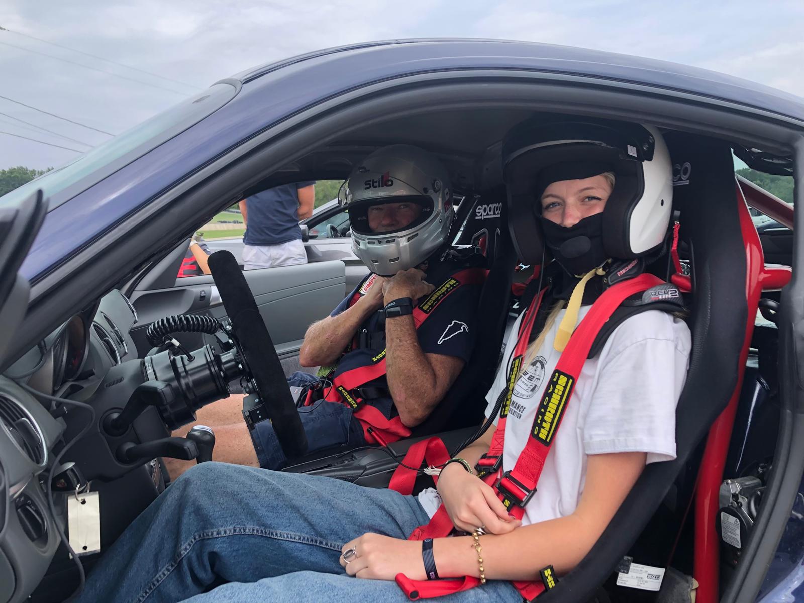 Suited up in racing helmets and harnesses for a track day